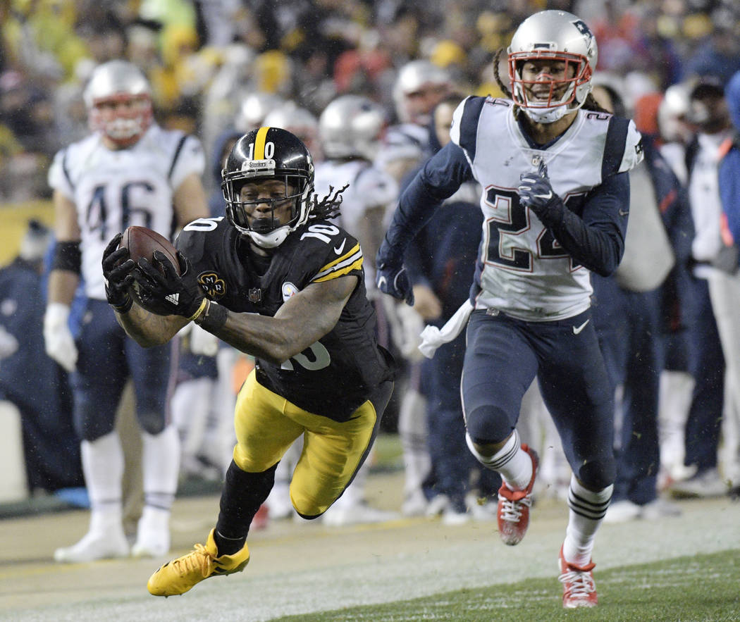 Pittsburgh Steelers wide receiver Martavis Bryant (10) dives to make a catch on a pass from quarterback Ben Roethlisberger with New England Patriots cornerback Stephon Gilmore (24) defending durin ...