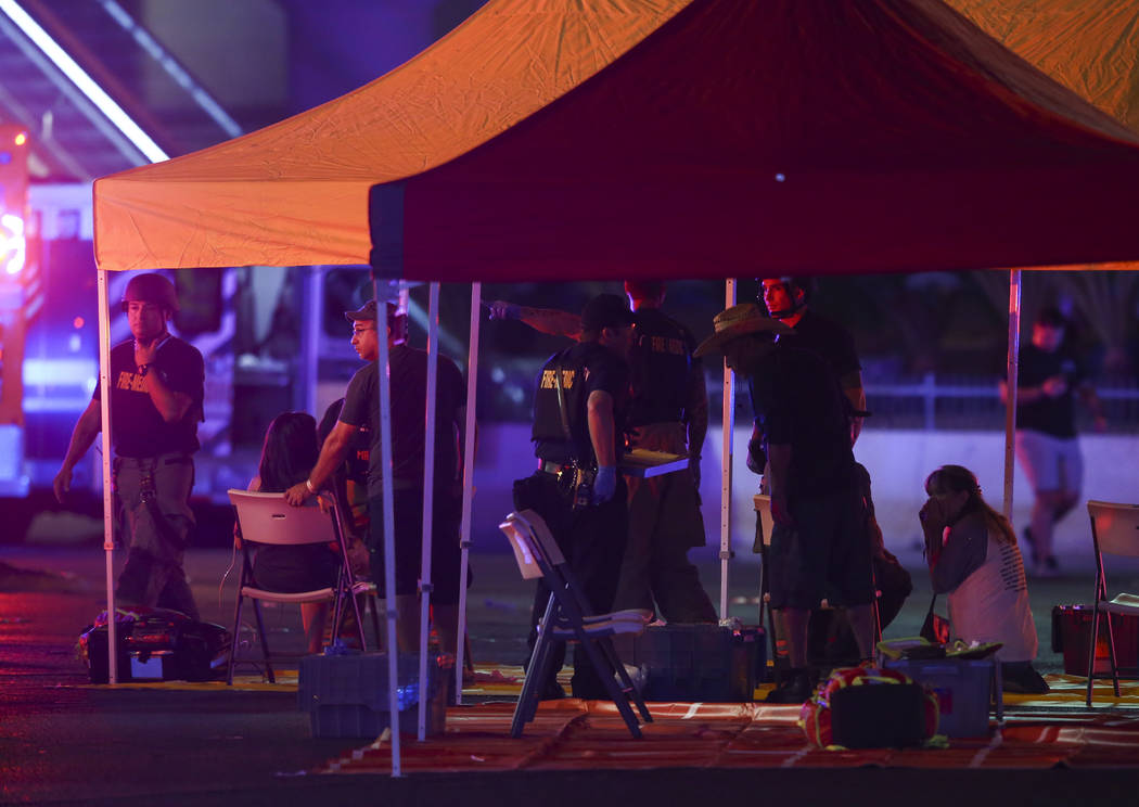 Emergency workers treat the wounded as Las Vegas police respond during an active shooter situation on the Las Vegas Strip in Las Vegas on Sunday, Oct. 1, 2017. Chase Stevens Las Vegas Review-Journ ...