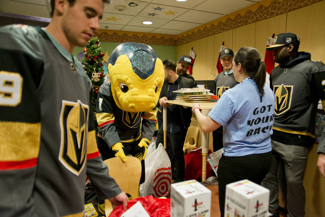 Players for the Vegas Golden Knights and others organize presents for children during an event at the Children's Hospital of Nevada at University Medical Center in Las Vegas on Thursday, Dec. 21,  ...