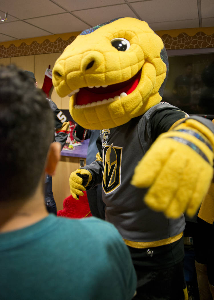 Vegas Golden Knights mascot Chance the Gila Monster greets Greco Alatorne during an event at the Children's Hospital of Nevada at University Medical Center in Las Vegas on Thursday, Dec. 21, 2017. ...