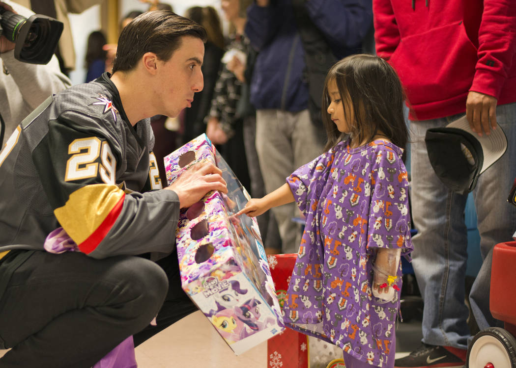 Vegas Golden Knights goaltender Marc-Andre Fleury gives a gift to Elleen Bautista Viveros during an event at the Children's Hospital of Nevada at University Medical Center in Las Vegas on Thursday ...