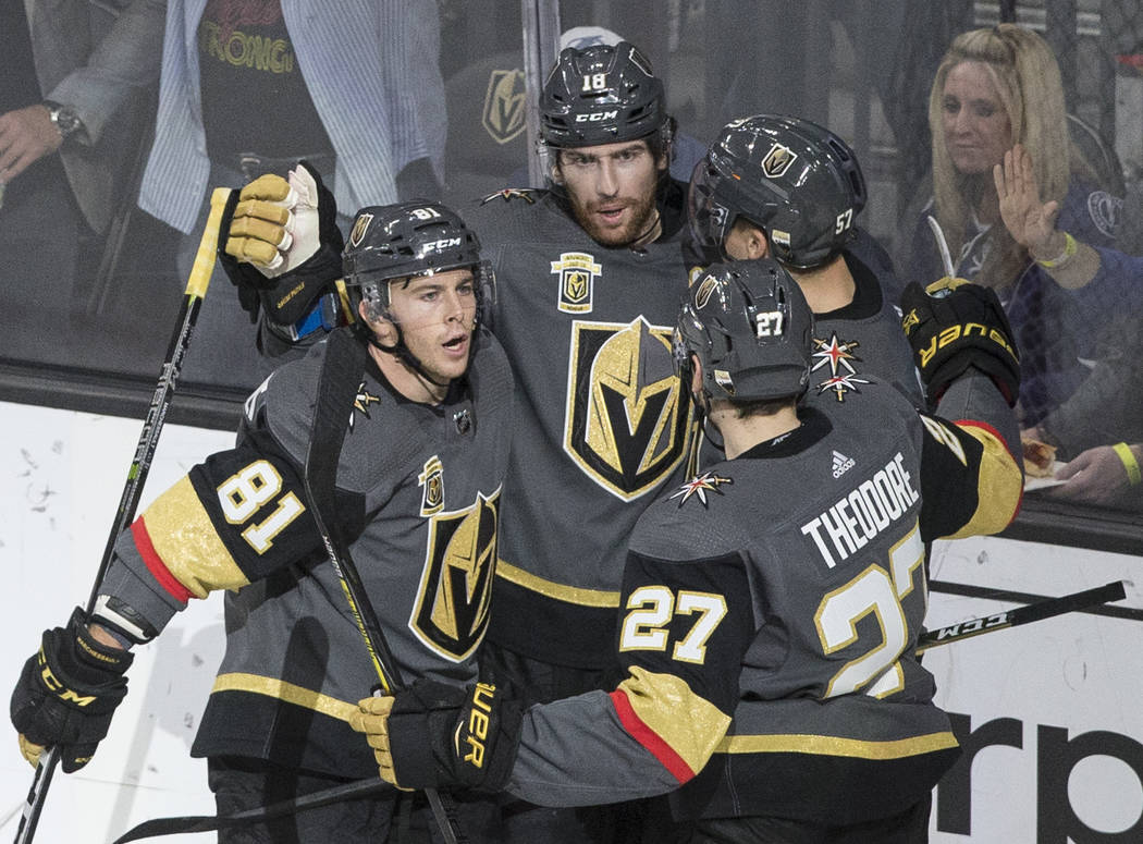 Golden Knights left wing James Neal (18) celebrates with center Jonathan Marchessault (81) and Shea Theodore (27) after scoring a second period goal during Vegas' home matchup with the Lighting on ...
