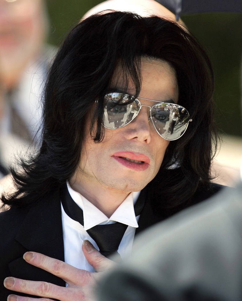 In this June 13, 2005 photo, Michael Jackson gestures as he leaves court during his trial on child molestation charges in Santa Maria, Calif. Wade Robson, who is now 35, testified at Jackson's cri ...