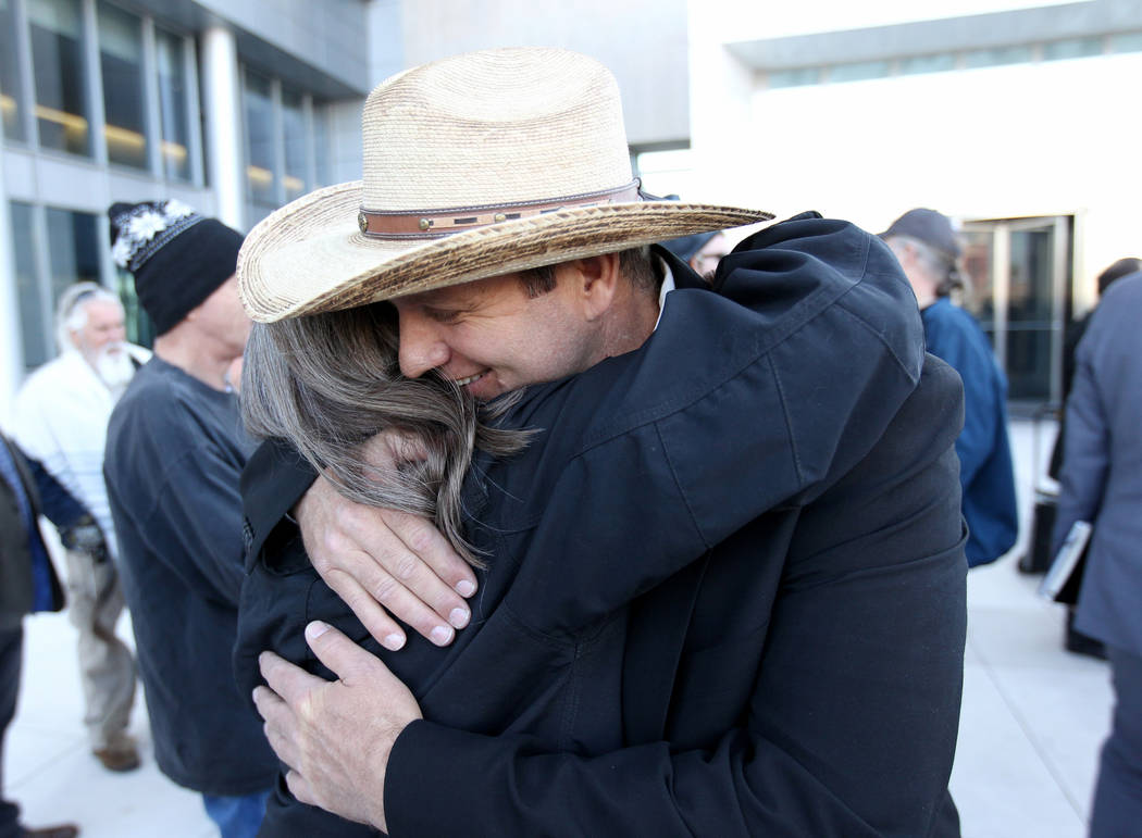 Defendant Ammon Bundy hugs supporter Terry Noonkester outside the Lloyd George U.S. Courthouse on Wednesday, Dec. 20, 2017, after a mistrial was declared in the Bunkerville standoff case. K.M. Can ...