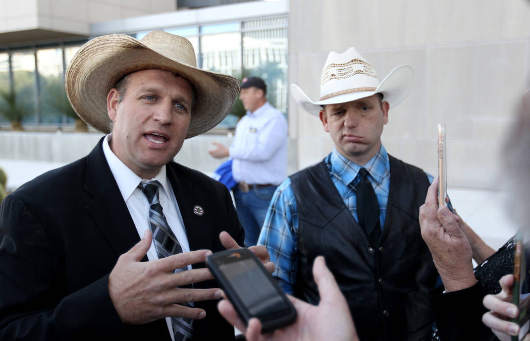 Defendants Ammon Bundy, left, and his brother Ryan Bundy, talk to the news media outside the Lloyd George U.S. Courthouse on Wednesday, Dec. 20, 2017, after a mistrial was declared in the Bunkervi ...