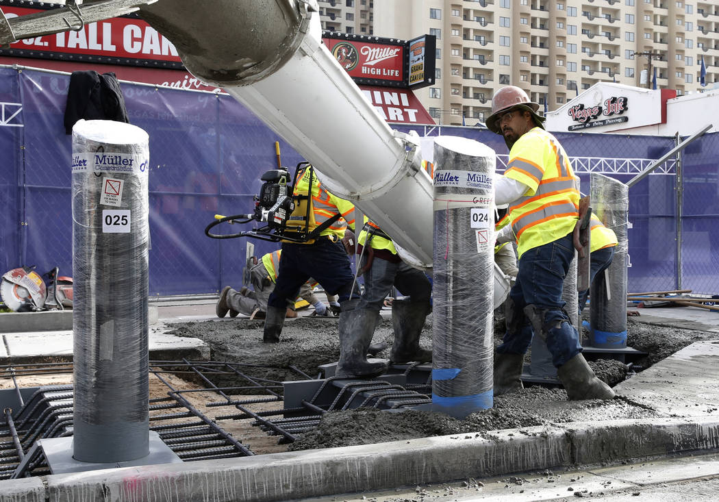 Construction crews pour cement where they began installing steel posts on the Strip near Aria on Monday, Nov. 13, 2017, to protect pedestrians along Las Vegas Boulevard. (Bizuayehu Tesfaye/Las Veg ...