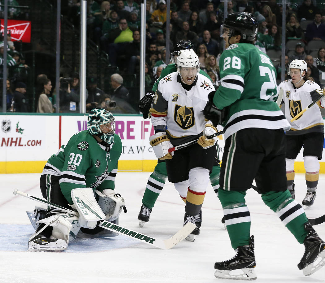 Dallas Stars goalie Ben Bishop (30) and defenseman Stephen Johns (28) watch as Vegas Golden Knights left wing James Neal (18) celebrates a goal scored by David Perron, not pictured in the second p ...