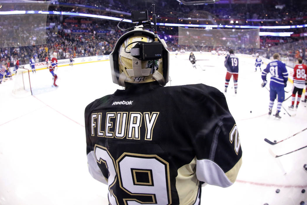 Pittsburgh Penguins goalie Marc-Andre Fleury wears a camera on his helmet during warm ups before the NHL All-Star hockey skills competition in Columbus, Ohio, Saturday, Jan. 24, 2015. (AP Photo/Ge ...