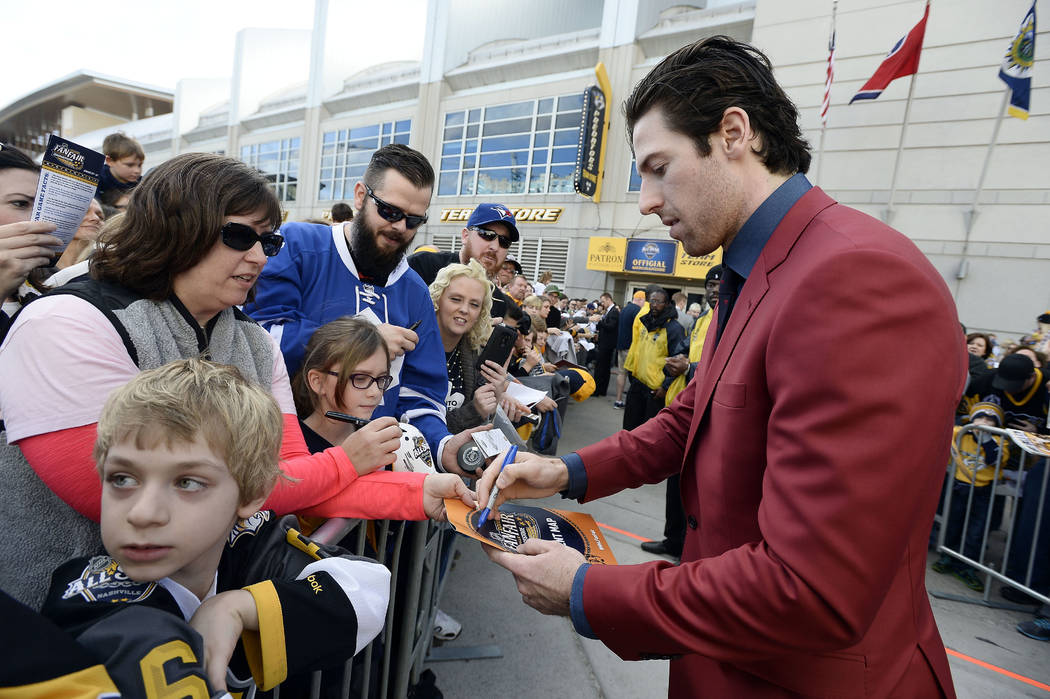 Nashville Predators forward James Neal signs autographs as he arrives for the NHL hockey All-Star game Sunday, Jan. 31, 2016, in Nashville, Tenn. (AP Photo/Mark Zaleski)