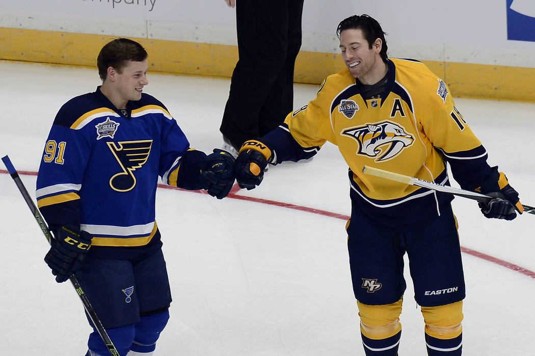 St. Louis Blues forward Vladimir Tarasenko (91), of Russia, celebrates with Nashville Predators forward James Neal (18) after competing in the challenge relay at the NHL hockey All-Star game skill ...