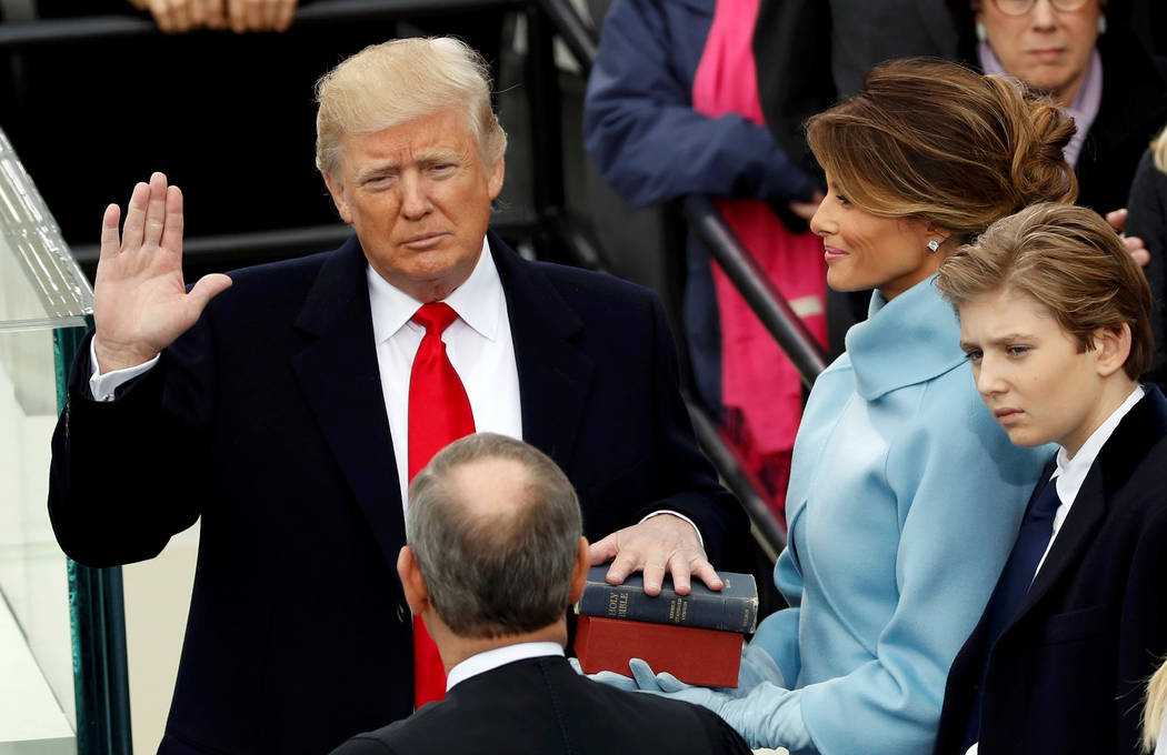 US President Donald Trump takes the oath of office with his wife Melania and son Barron at his side, during his inauguration at the U.S. Capitol in Washington, U.S., January 20, 2017. REUTERS/Kevi ...