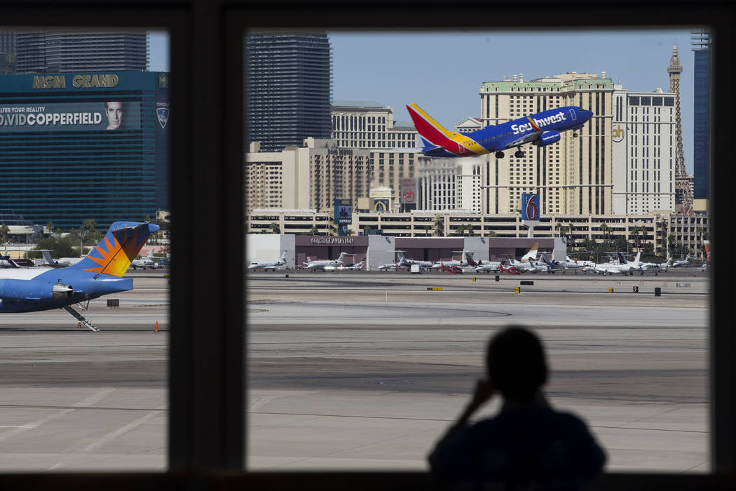 A silhouetted child watches as plane takes the air from McCarran International Airport in Las Vegas. Erik Verduzco Las Vegas Review-Journal @Erik_Verduzco