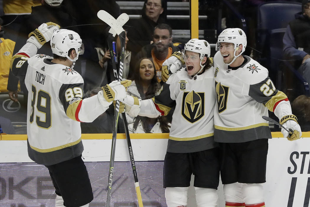 Vegas Golden Knights left wing Erik Haula, center, of Finland, celebrates with Alex Tuch (89) and Shea Theodore (27) after scoring the tying goal against the Nashville Predators in the final minut ...