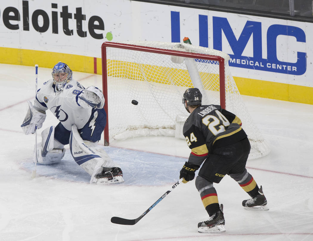 Tampa Bay goaltender Andrei Vasilevskiy (88) makes a save against Golden Knights center Oscar Lindberg (24) in the second period during the Lightning's road matchup with Vegas on Tuesday, Dec. 19 ...