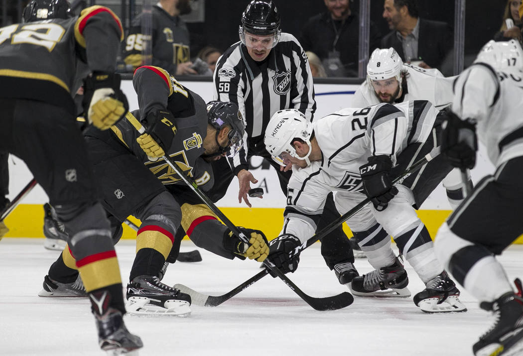 Vegas Golden Knights left wing Pierre-Edouard Bellemare (41) and Los Angeles Kings center Nic Dowd (26) face off during the second period of an NHL hockey game at the T-Mobile Arena in Las Vegas o ...