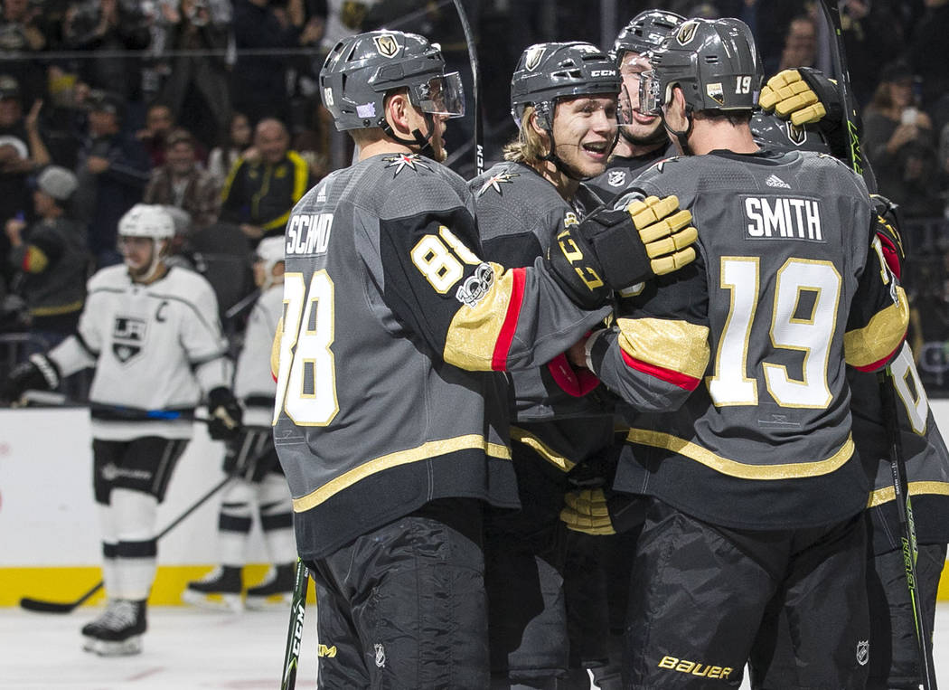 Vegas Golden Knights center William Karlsson, center, celebrates with teammates after scoring against the Los Angeles Kings during the first period of an NHL hockey game at the T-Mobile Arena in L ...