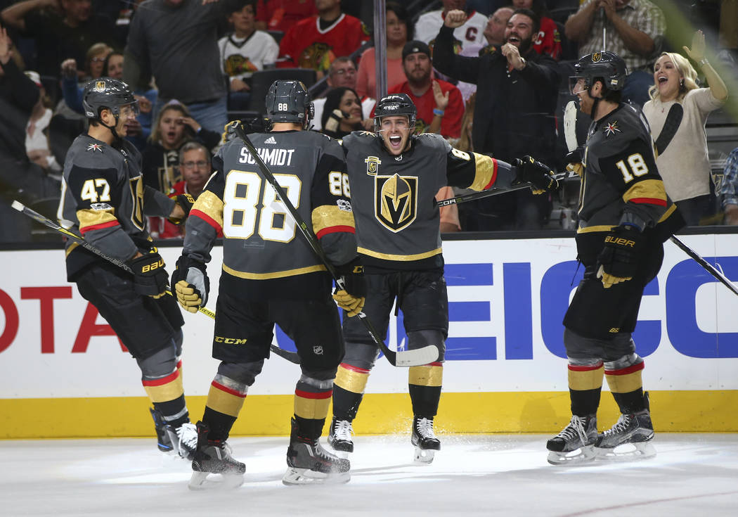 Golden Knights' Jonathan Marchessault, third from left, celebrates his goal against the Chicago Blackhawks with teammates during an NHL hockey game at T-Mobile Arena in Las Vegas on Tuesday, Oct.  ...