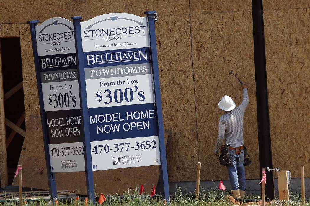A construction worker continues work on new town homes under construction in Woodstock, Ga, Tuesday, May 16, 2017. The Standard & Poor's CoreLogic Case-Shiller home price index, which tracks t ...