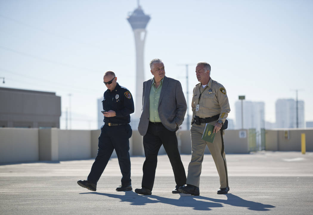 Clark County officials, from left, Fire Chief Greg Cassell, Commissioner Steve Sisolak, and Sheriff Joe Lombardo leave after a news conference on New Year's Eve security at the Las Vegas Metropoli ...