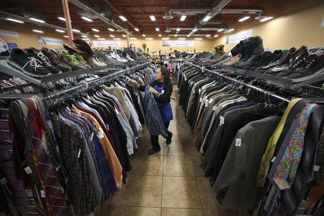 Cashier Imelda Burtless organizes items in the men's aisle at the Goodwill store located at 1390 American Pacific Drive in Henderson on Thursday, Dec. 28, 2017. Richard Brian Las Vegas Review-Jour ...