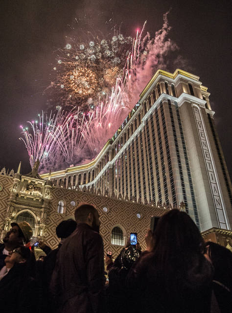 New Year's Eve party goers watch the fireworks outside the Venetian hotel-casino on the Strip on Saturday, Dec. 31, 2016, in Las Vegas. (Benjamin Hager/Las Vegas Review-Journal)