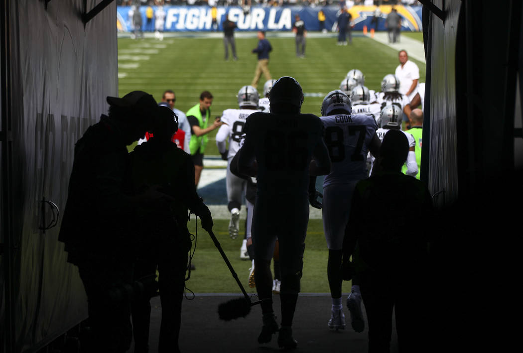 Oakland Raiders players take the field to warm up before playing the Los Angeles Chargers in an NFL game at StubHub Center in Carson, Calif. on Sunday, Dec. 31, 2017. (Chase Stevens/Las Vegas Revi ...