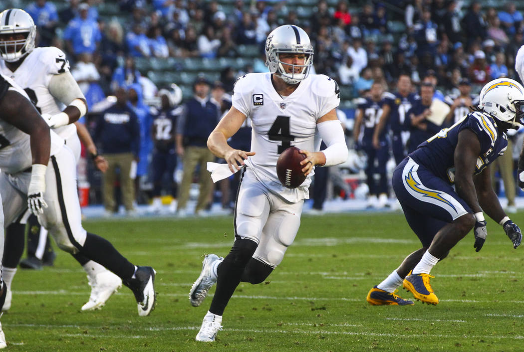 Oakland Raiders quarterback Derek Carr (4) runs the ball against the Los Angeles Chargers during an NFL game at StubHub Center in Carson, Calif. on Sunday, Dec. 31, 2017. Chase Stevens Las Vegas R ...