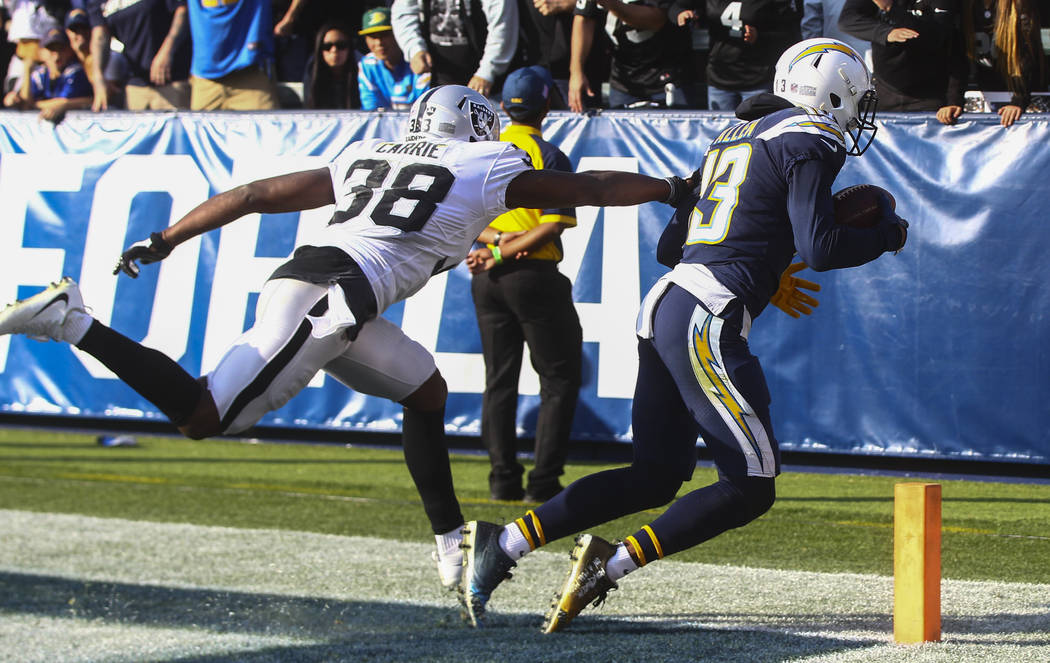 Los Angeles Chargers wide receiver Keenan Allen (13) scores a touchdown past Oakland Raiders cornerback T.J. Carrie (38) during an NFL game at StubHub Center in Carson, Calif. on Sunday, Dec. 31,  ...