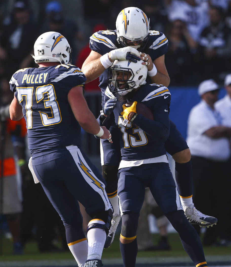 Los Angeles Chargers wide receiver Keenan Allen (13) celebrates his touchdown with Spencer Pulley (73) and Sean McGrath (84) during an NFL game against the Oakland Raiders at StubHub Center in Car ...