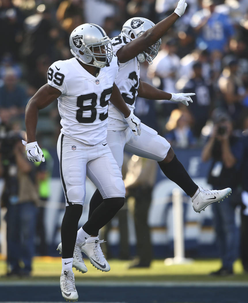 Oakland Raiders wide receiver Amari Cooper (89) celebrates his touchdown with running back Jalen Richard (30) during an NFL game against the Los Angeles Chargers at StubHub Center in Carson, Calif ...