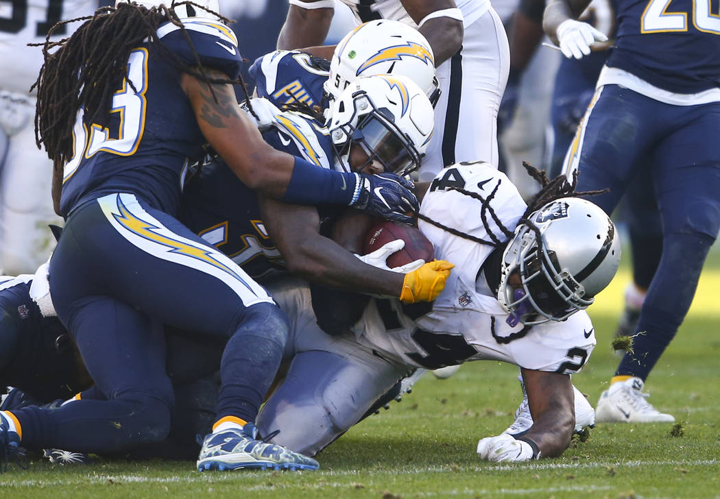 Oakland Raiders running back Marshawn Lynch (24) is taken down by Los Angeles Chargers defense during an NFL game at StubHub Center in Carson, Calif. on Sunday, Dec. 31, 2017. Chase Stevens Las Ve ...