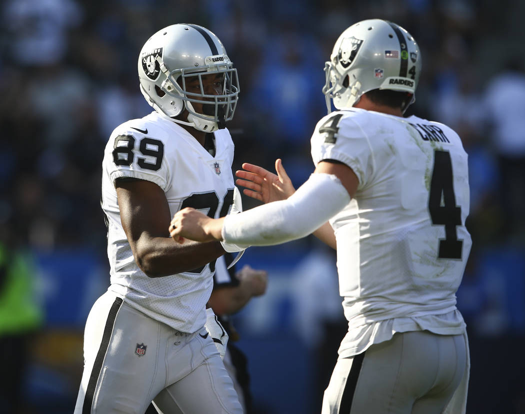 Oakland Raiders wide receiver Amari Cooper (89) celebrates his touchdown with quarterback Derek Carr (4) during an NFL game against the Los Angeles Chargers at StubHub Center in Carson, Calif. on  ...