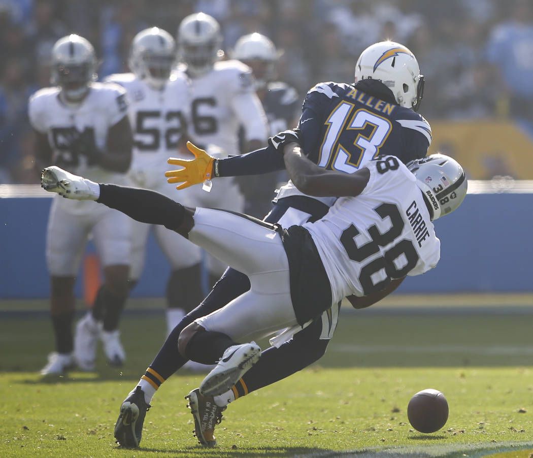Oakland Raiders cornerback T.J. Carrie (38) breaks up a pass intended for Los Angeles Chargers wide receiver Keenan Allen (13) during an NFL game at StubHub Center in Carson, Calif. on Sunday, Dec ...