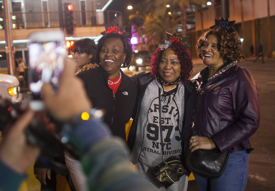 Natlynn Johnson, from left, Ruby Shearry, and Pat Gaffney have their picture taken with New Year crowns on in downtown Las Vegas, Sunday, Dec. 31, 2017. Rachel Aston Las Vegas Review-Journal @rook ...