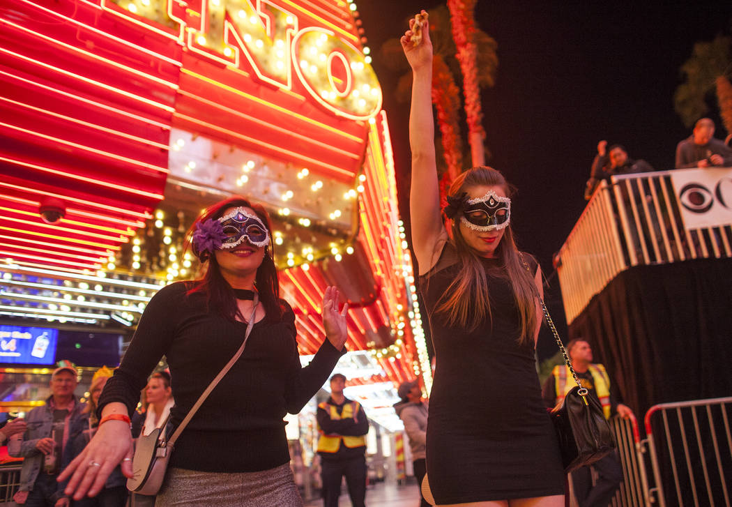 Devilan Chaney, left, and Panda Chaney dance at the Fremont Street Experience in Las Vegas, Sunday, Dec. 31, 2017. Rachel Aston Las Vegas Review-Journal @rookie__rae