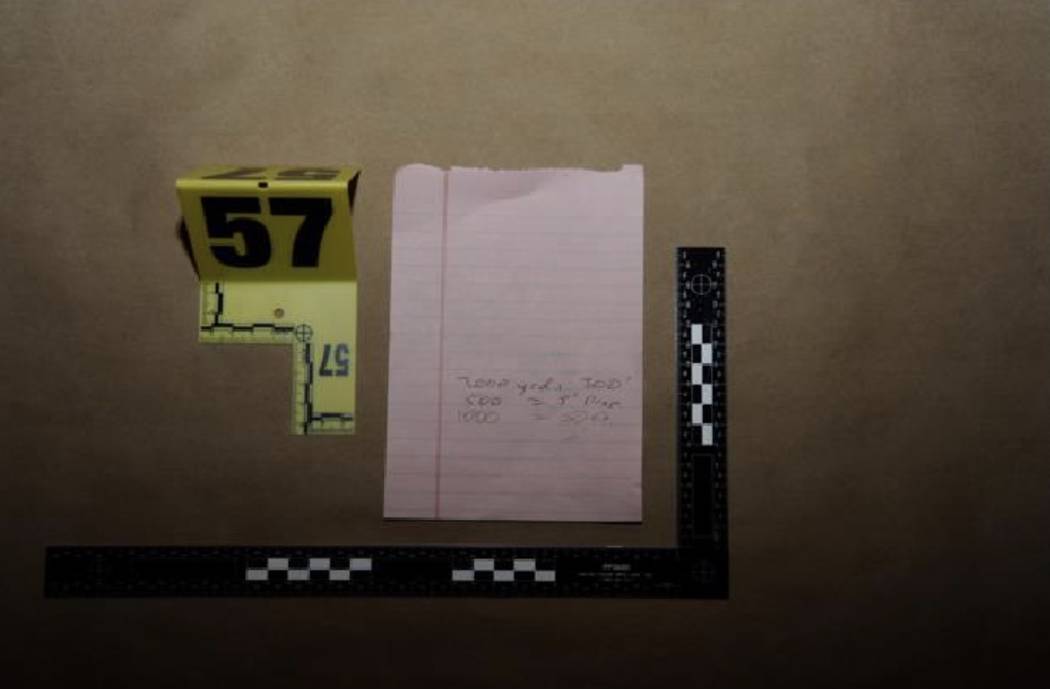 A handwritten note with distance and bullet drop calculations. LVMPD.
