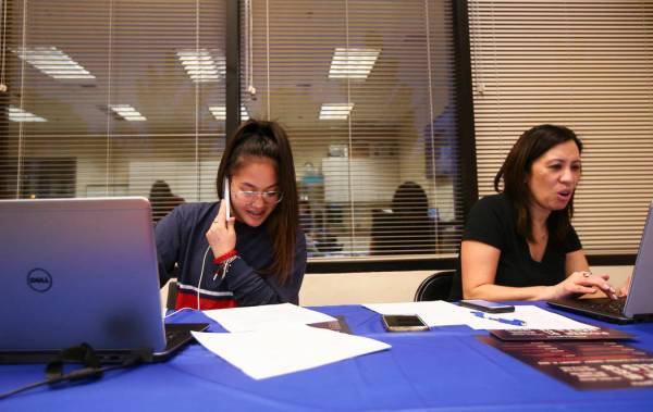Danielle Chio, left, with her stepmother Nyah, make calls during a ...