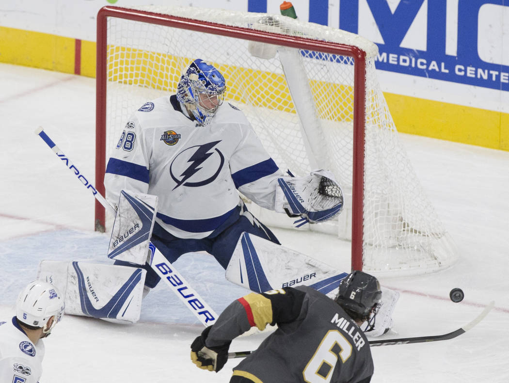Tampa Bay goaltender Andrei Vasilevskiy (88) makes a save against Golden Knights defenseman Colin Miller (6) in the second period during the Lightning's road matchup with Vegas on Tuesday, Dec. 19 ...