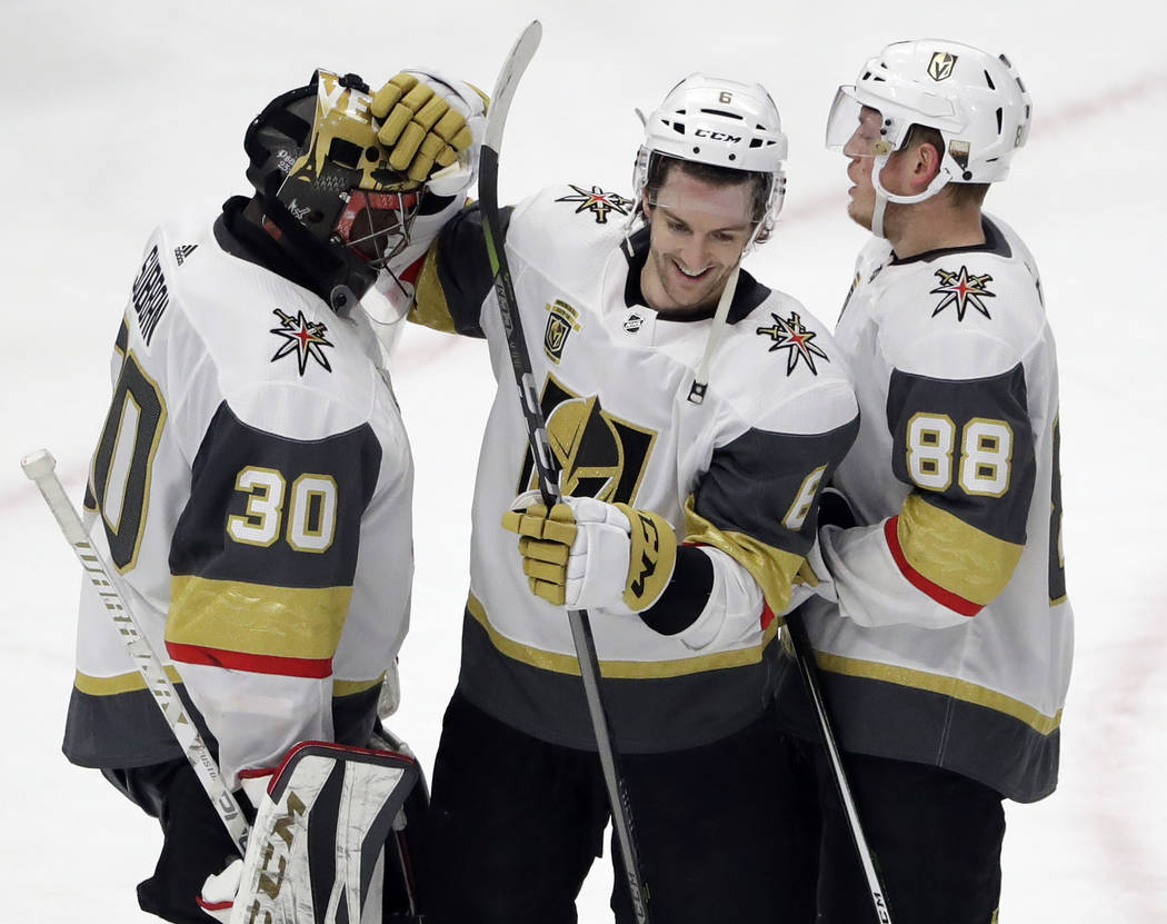 Vegas Golden Knights goalie Malcolm Subban, left, celebrates with defensemen Colin Miller, center, and Nate Schmidt after they defeated the Chicago Blackhawks in an NHL hockey game Friday, Jan. 5, ...