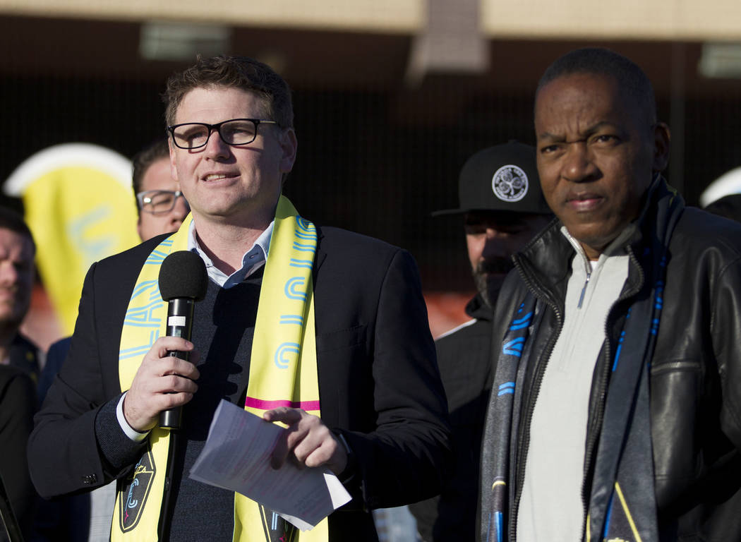 Las Vegas Lights FC owner Brett Lashbrook, left, with Clark County Commissioner Lawrence Weekly, during an event to
lay the first pieces of turf at Cashman Field to help transition the stadium fro ...