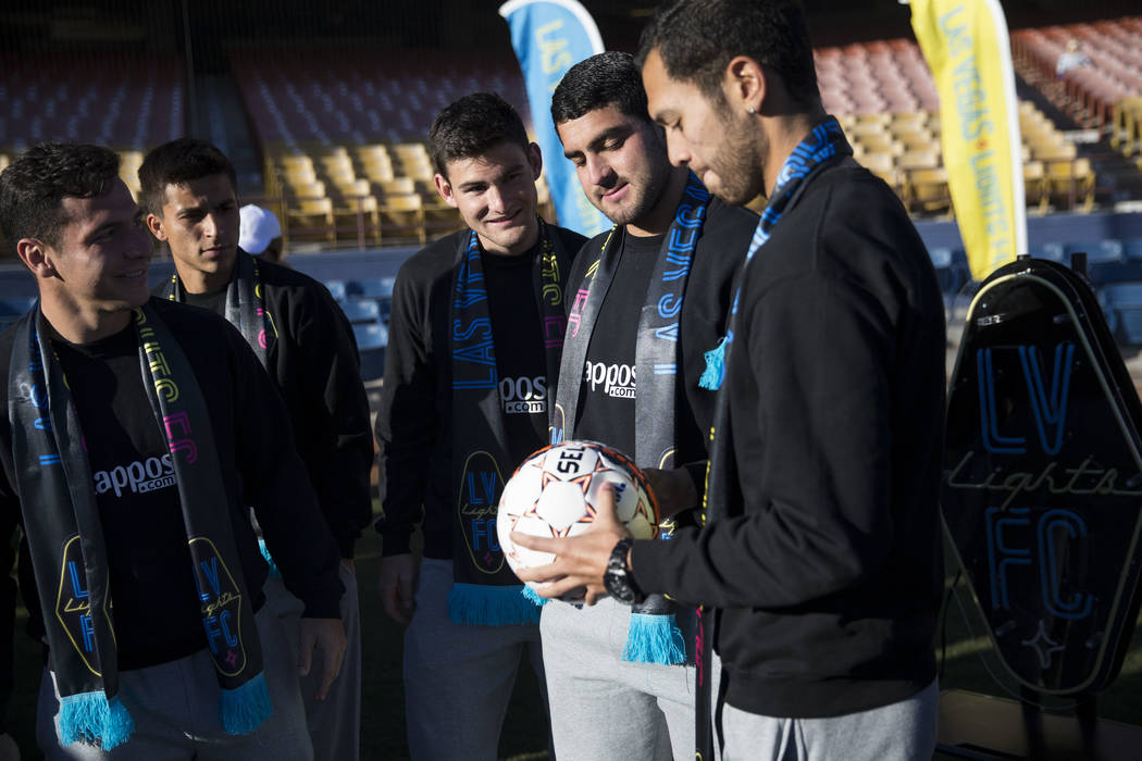 Las Vegas Lights FC players from left, Julian Portugal, Adolfo Guzman, Matt Thomas, Marco Cesar Jaime, and Sebastian Hernandez, during an event to lay the first pieces of turf at Cashman Field to  ...