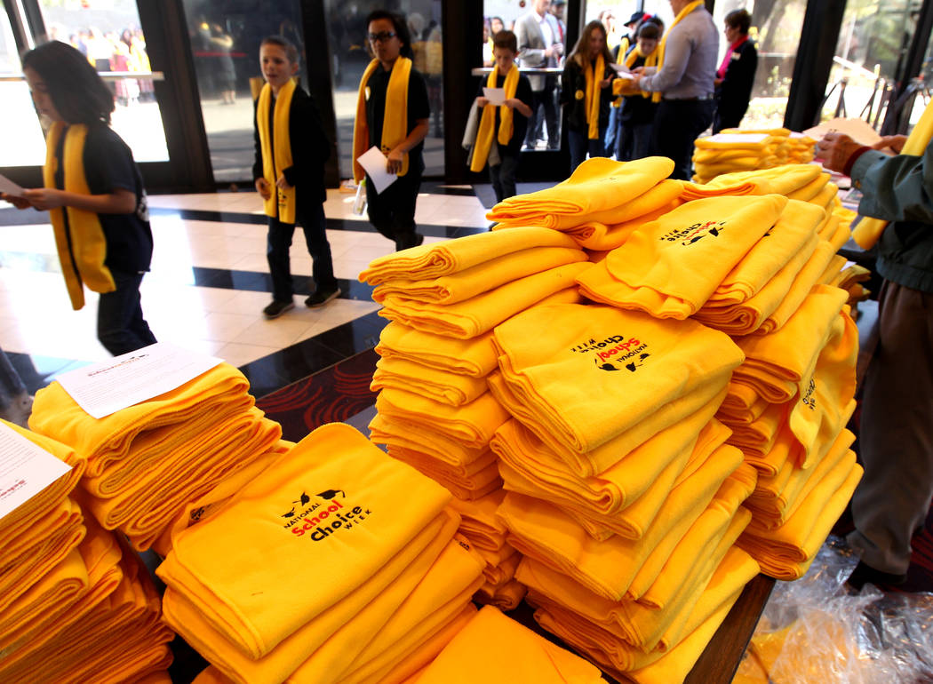 Students are given scarves as they arrive at UNLV to celebrate National School Choice Week Tuesday, Jan. 23, 2018. Over 1,800 students, teacher and families watched several student performances at ...