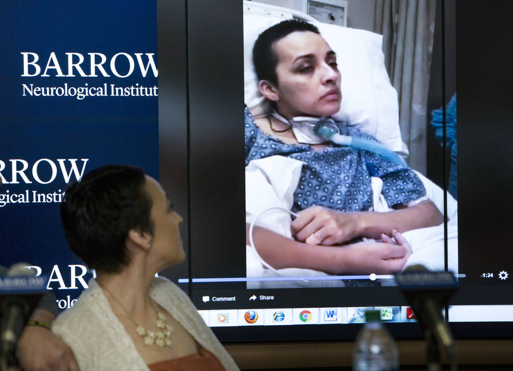 Route 91 Harvest shooting festival survivor Jovanna Calzadillas of San Tan Valley, Ariz. watches a video clip of herself in a hospital bed during a press conference on her recovery at the Barrow N ...
