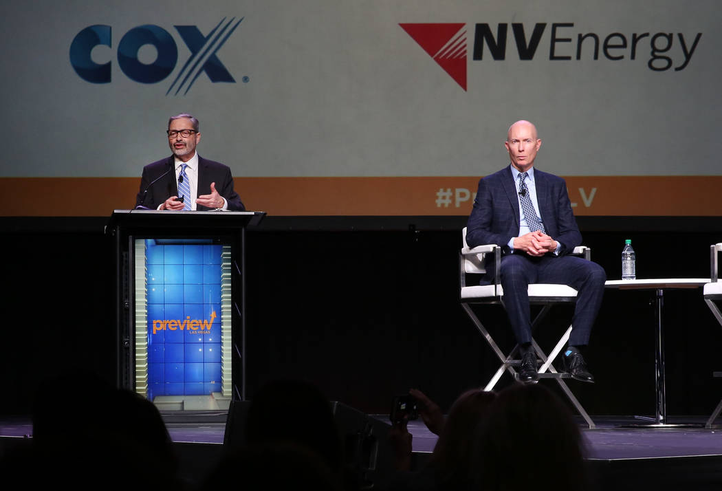 Mike PeQueen, right, of HighTower Las Vegas listens as John Restrepo of RCG Economics speaks during Preview Las Vegas, the Las Vegas Metropolitan Chamber of Commerce’s largest annual networ ...
