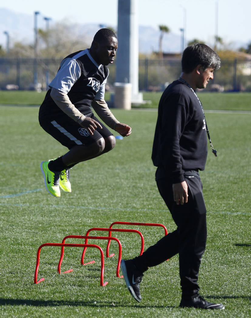 Former U.S. national team member Freddy Adu tries out for the Las Vegas Lights FC as coach Jose Luis Sanchez Sola walks by at the team's practice field in Las Vegas, Tuesday, Jan. 23, 2018. Heidi  ...