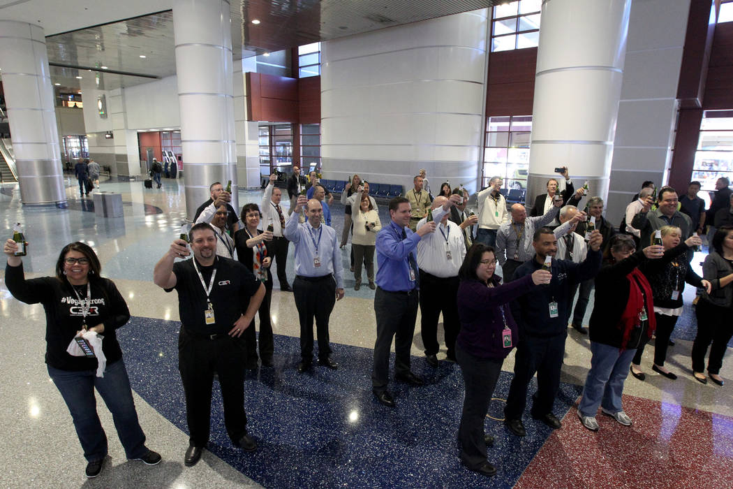 Employees toast with sparkling cider at McCarran International Airport during a celebration Wednesday, Jan. 24, 2018, marking the completion of a $30 million Terminal 1 renovation project. The ter ...