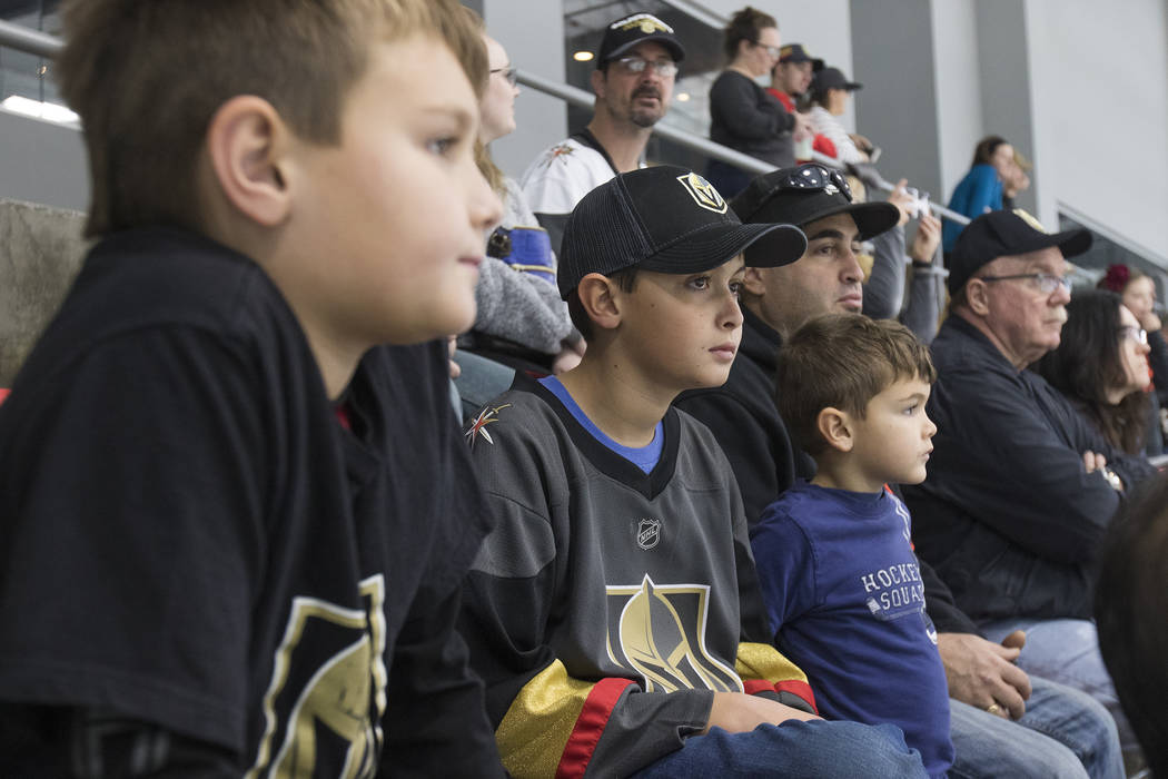 Mason Leoncavallo, 9, watches the Vegas Golden Knights practice alongside his brothers Trevor Leoncavallo, 11, and Logan Leoncavallo, 6, and his dad Victor Leoncavallo at the City National Arena i ...