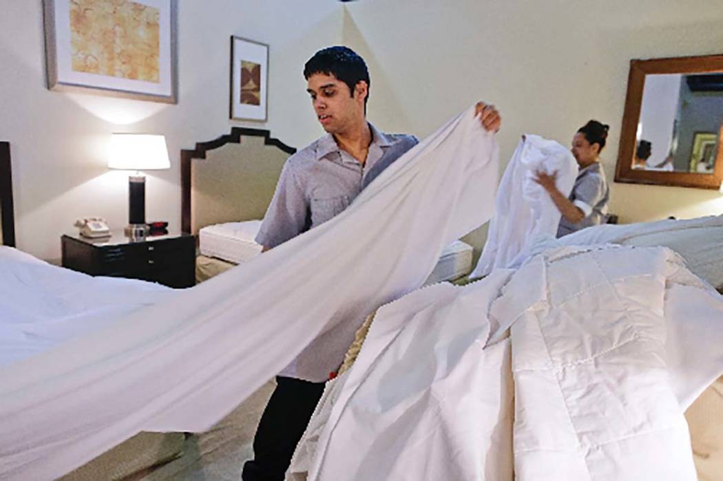 Nemias Ayala, left, and Mailen Gonzales practice stripping and making hotel room beds in a class at the Culinary Academy of Las Vegas. The Culinary union has stayed strong with the support of Lati ...