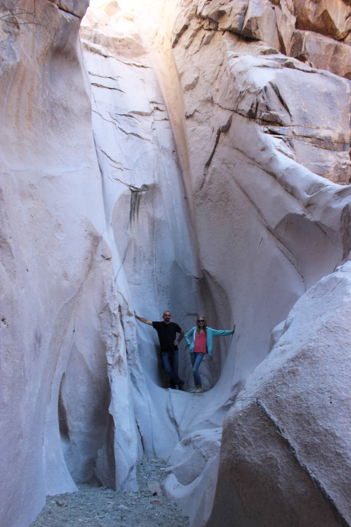 Visitors stand at the base of a dryfall in Keyhole Canyon. (Deborah Wall)