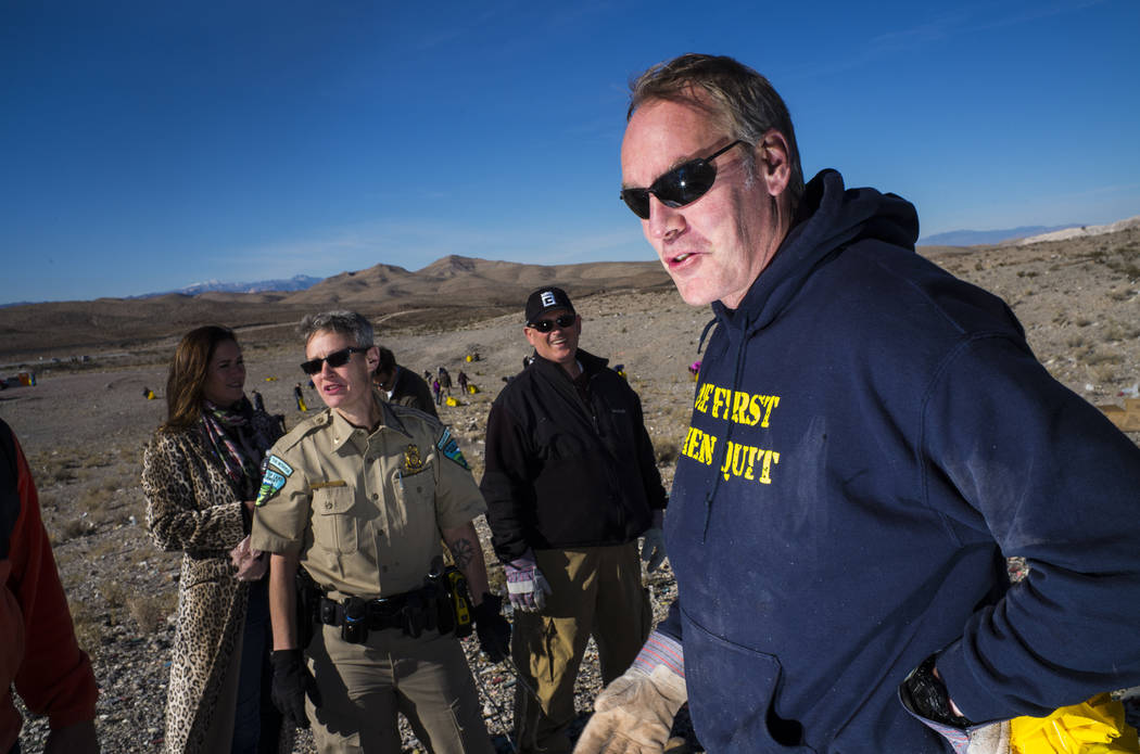Interior Secretary Ryan Zinke joins volunteers and Bureau of Land Management employees in cleaning up a shooting range area on public land along Las Vegas Boulevard just south of Sloan on Friday,  ...